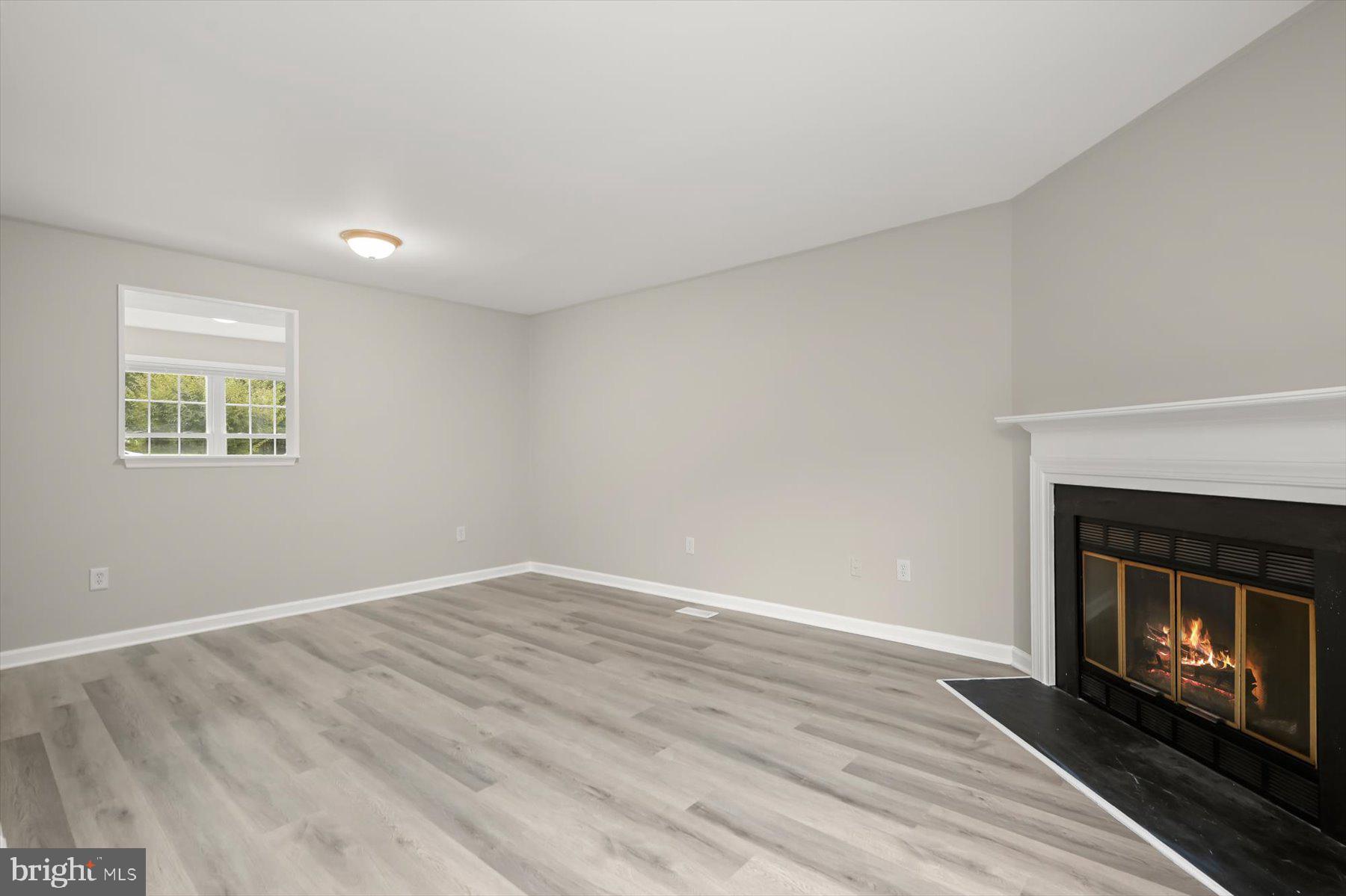 17 Offspring Court Perry Hall, MD 21128 - Photo 7 of 42 a view of an empty room with a fireplace and a window