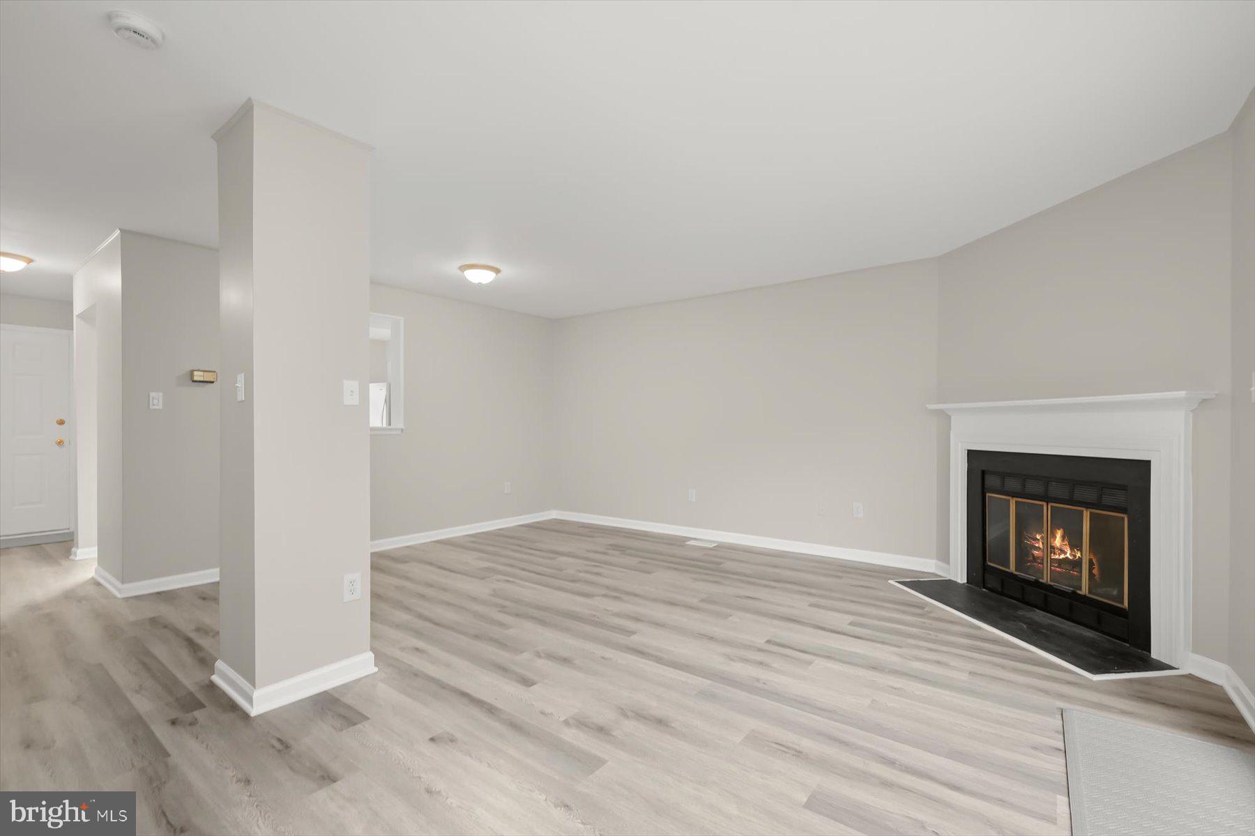 17 Offspring Court Perry Hall, MD 21128 - Photo 8 of 42 a view of an empty room with wooden floor fireplace and a window