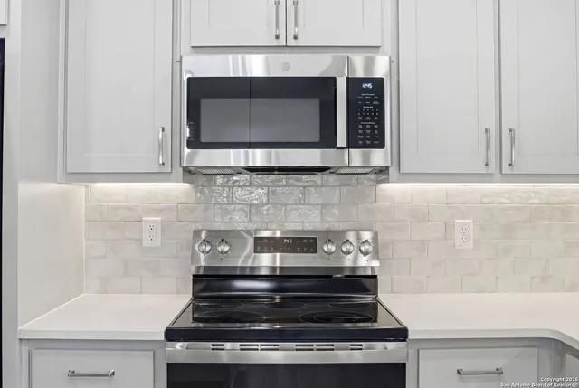 a stove top oven sitting inside of a kitchen