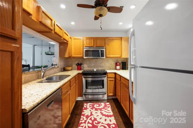 a kitchen with a stove sink and microwave