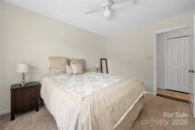 a bedroom with a bed and a mirror