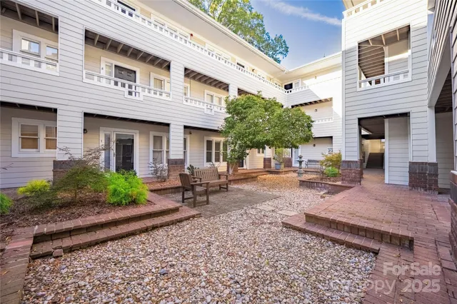 a backyard of a house with outdoor seating