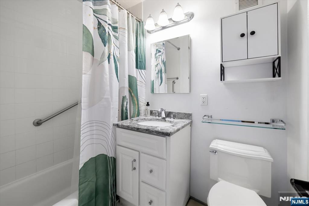 1 Horizon Road, Unit 1209 Fort Lee, NJ 07024 - Photo 12 of 15 a bathroom with a granite countertop sink toilet and shower