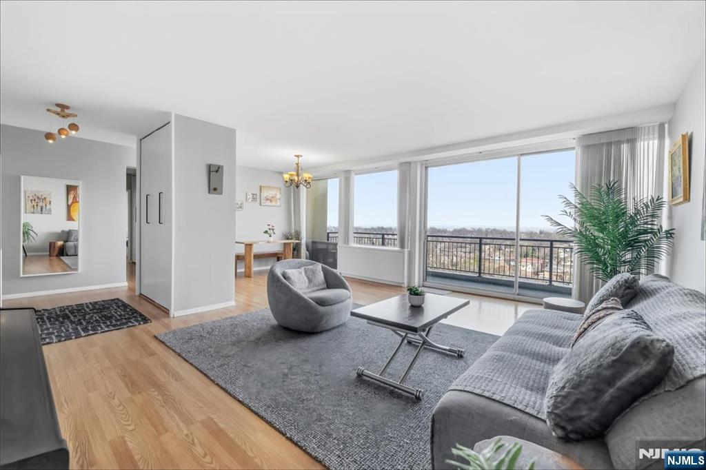 1 Horizon Road, Unit 1209 Fort Lee, NJ 07024 - Photo 3 of 15 a living room with furniture and a large window