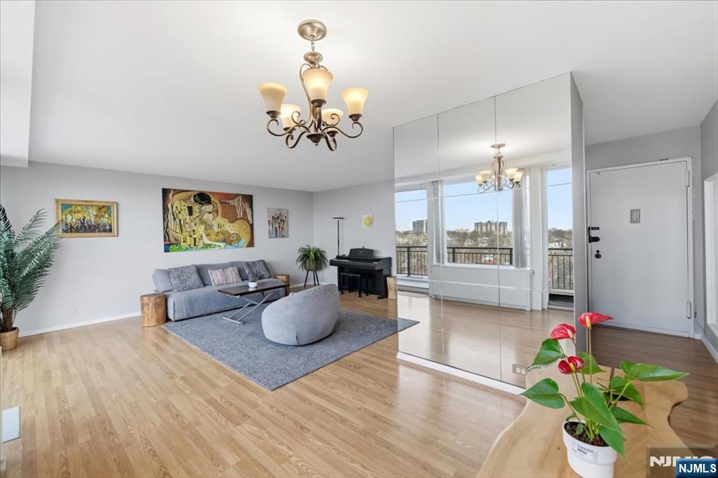 1 Horizon Road, Unit 1209 Fort Lee, NJ 07024 - Photo 4 of 15 a view of a dining room with furniture a potted plant and wooden floor