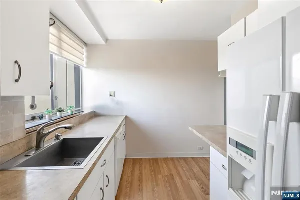 a kitchen with a sink stove and refrigerator