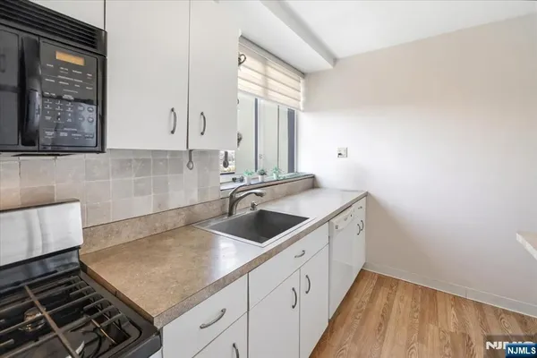 a kitchen with sink cabinets and stove
