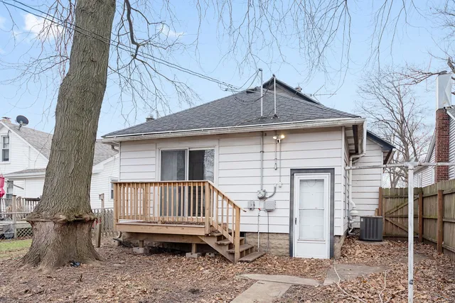 a view of a house with a yard and wooden fence