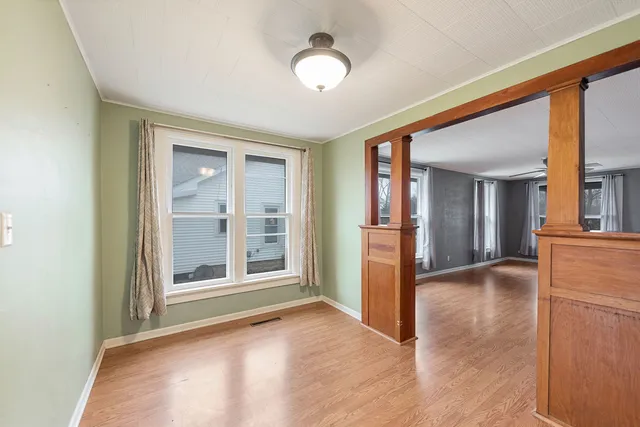 wooden floor in an empty room with a window