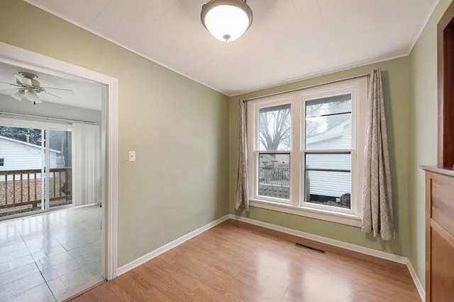 an empty room with windows and closet