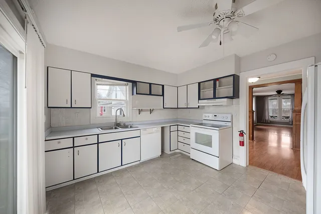 a kitchen with stainless steel appliances a sink and cabinets
