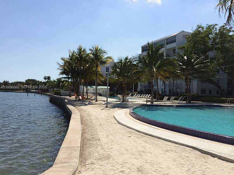 700 Northeast 63rd Street, Unit D609 Miami, FL 33138 - Photo 4 of 7 a view of swimming pool with outdoor seating and lake view