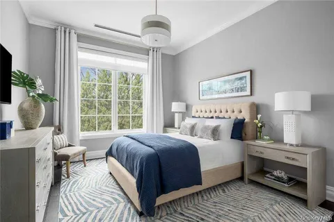 a bedroom with a large bed and a window