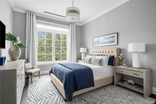 a bedroom with a large bed and a window