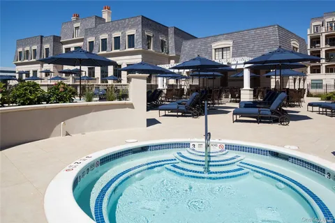 a swimming pool with outdoor seating and yard