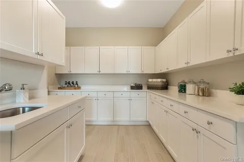 a kitchen with cabinets appliances a sink and a cabinets