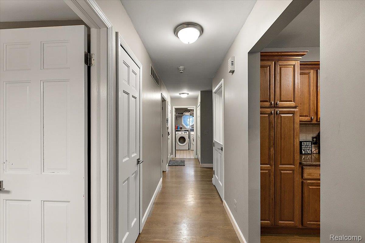 707 West Sutton Road Metamora, MI 48455 - Photo 38 of 84 Hallway featuring wood-finish flooring, recessed lighting, and white panel doors