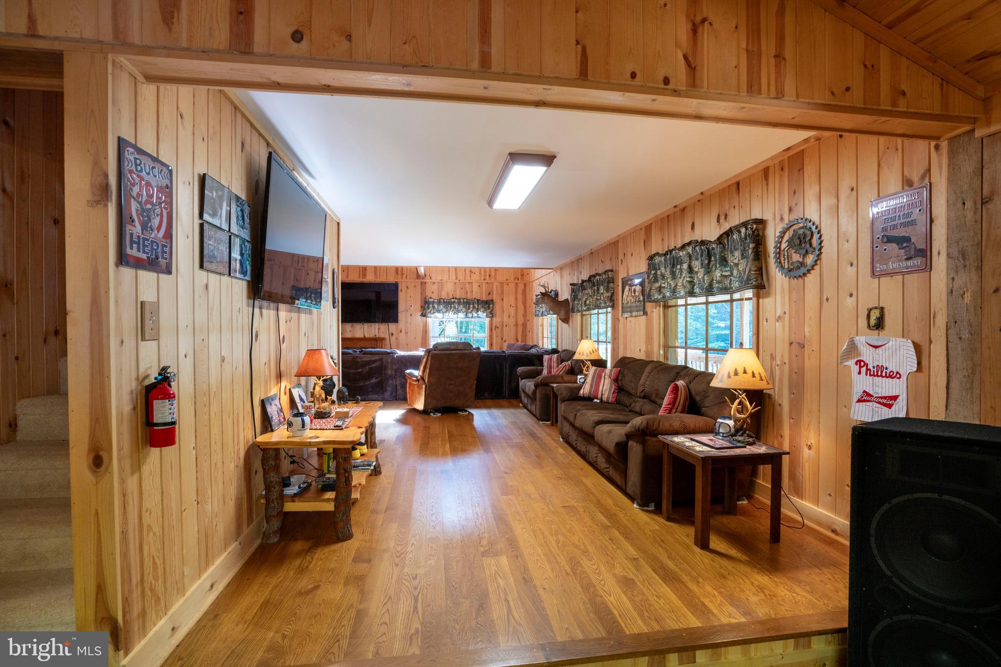 385 Elk Creek Road Aaronsburg, PA 16820 - Photo 12 of 71 a living room with furniture and a flat screen tv