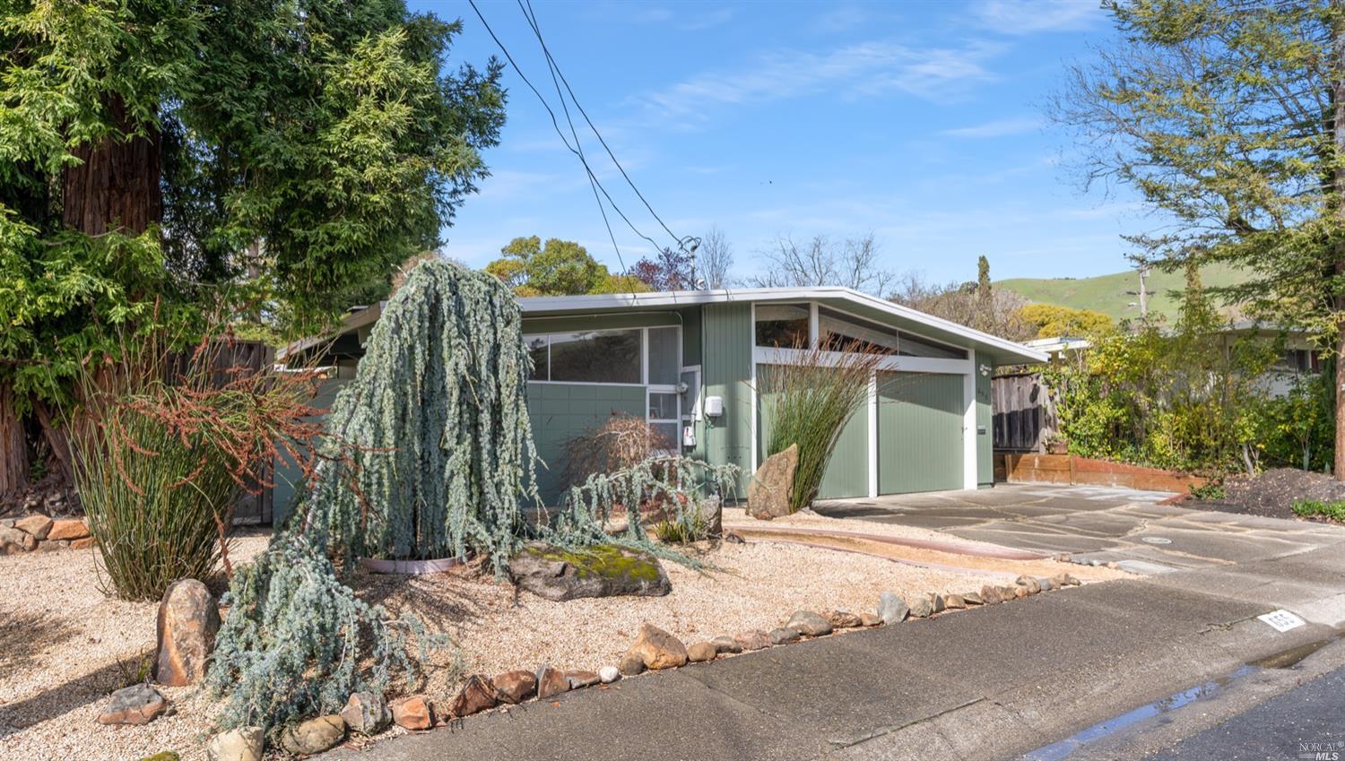 655 Wakerobin Lane San Rafael, CA 94903 - Photo 1 of 1 a front view of a house with a yard and potted plants