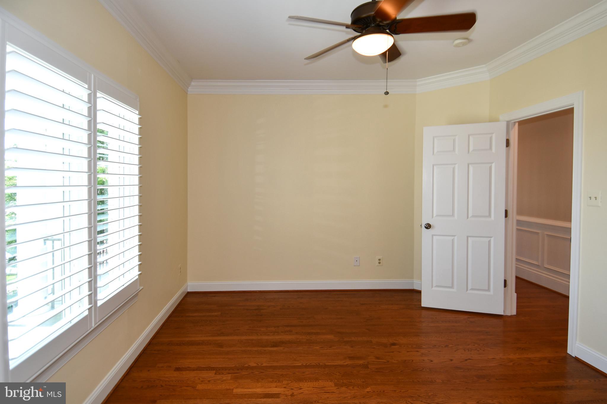 7808 Southdown Road Alexandria, VA 22308 - Photo 76 of 99 a view of an empty room with wooden floor and a window