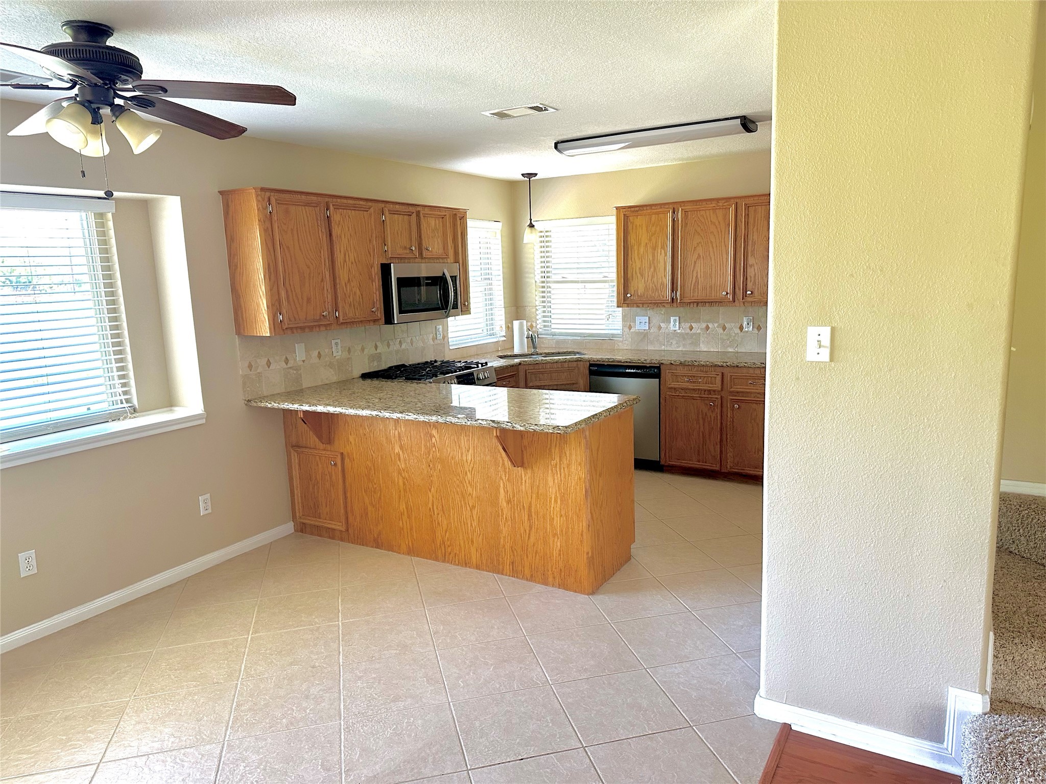 19303 Becker Road Hockley, TX 77447 - Photo 7 of 17 a kitchen with a sink a counter top space and a window