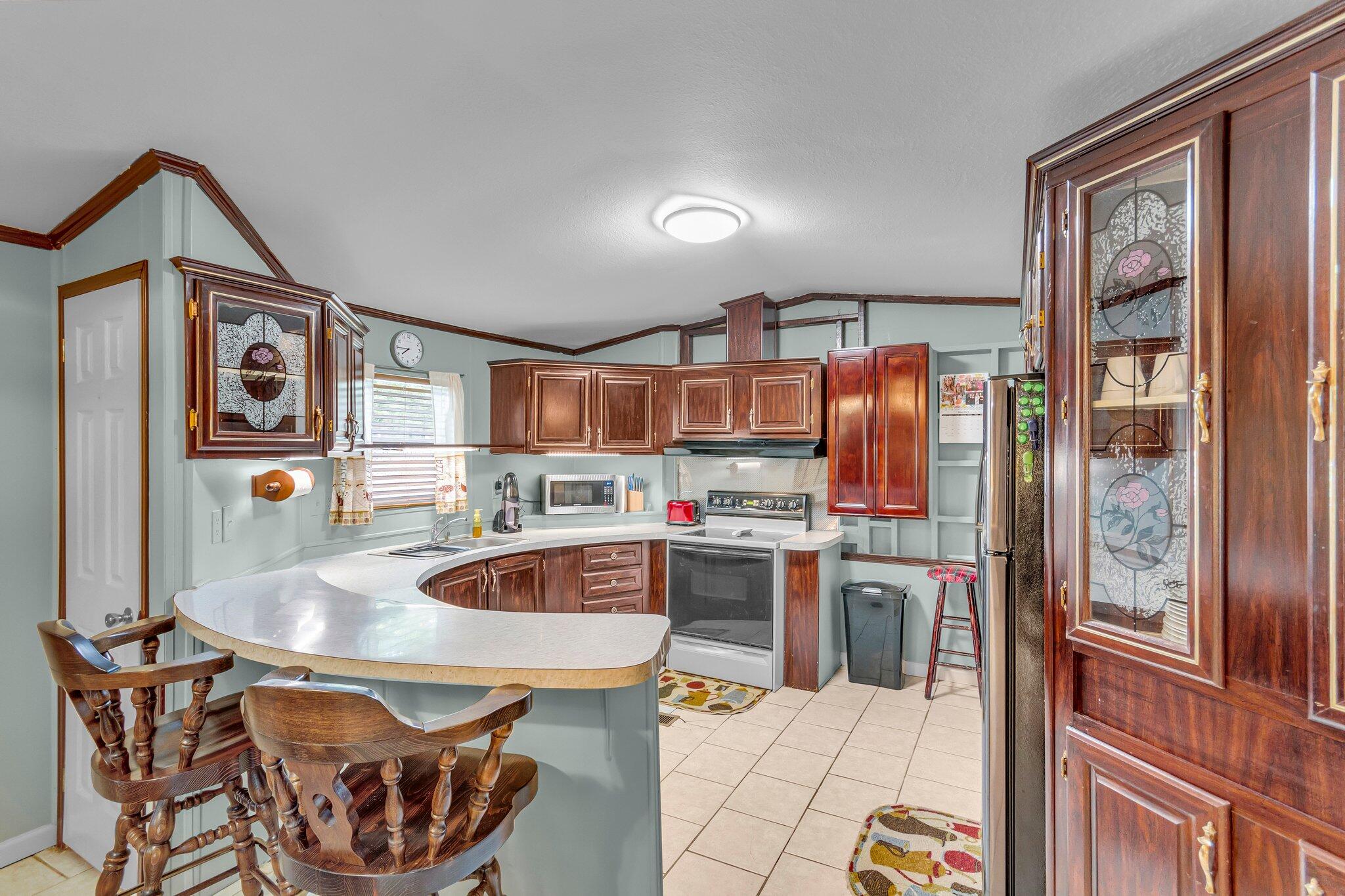 2 Sarah Lane Fort Walton Beach, FL 32547 - Photo 12 of 41 a kitchen with stainless steel appliances granite countertop a sink and a refrigerator