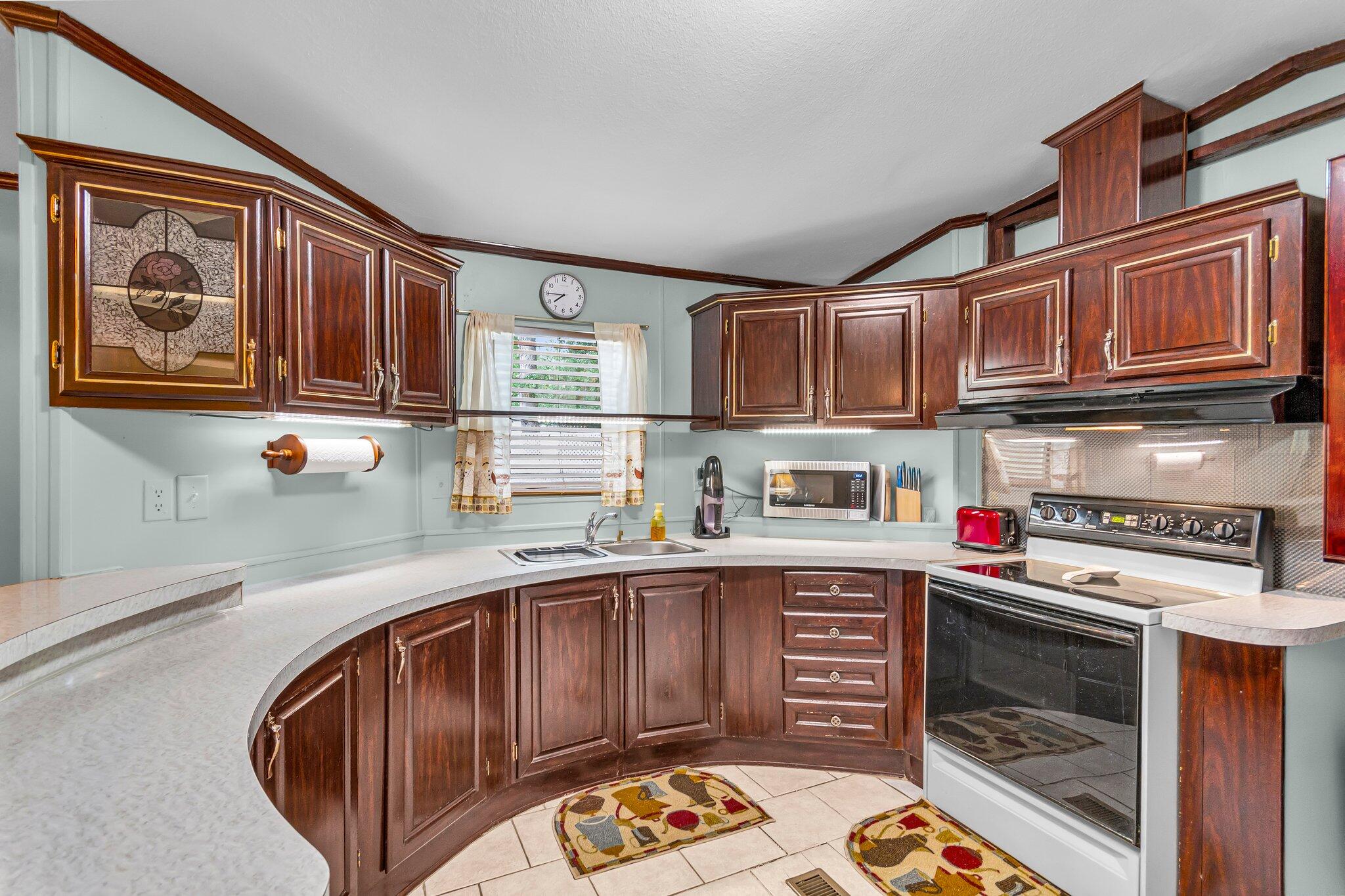 2 Sarah Lane Fort Walton Beach, FL 32547 - Photo 14 of 41 a kitchen with stainless steel appliances granite countertop a stove and cabinets