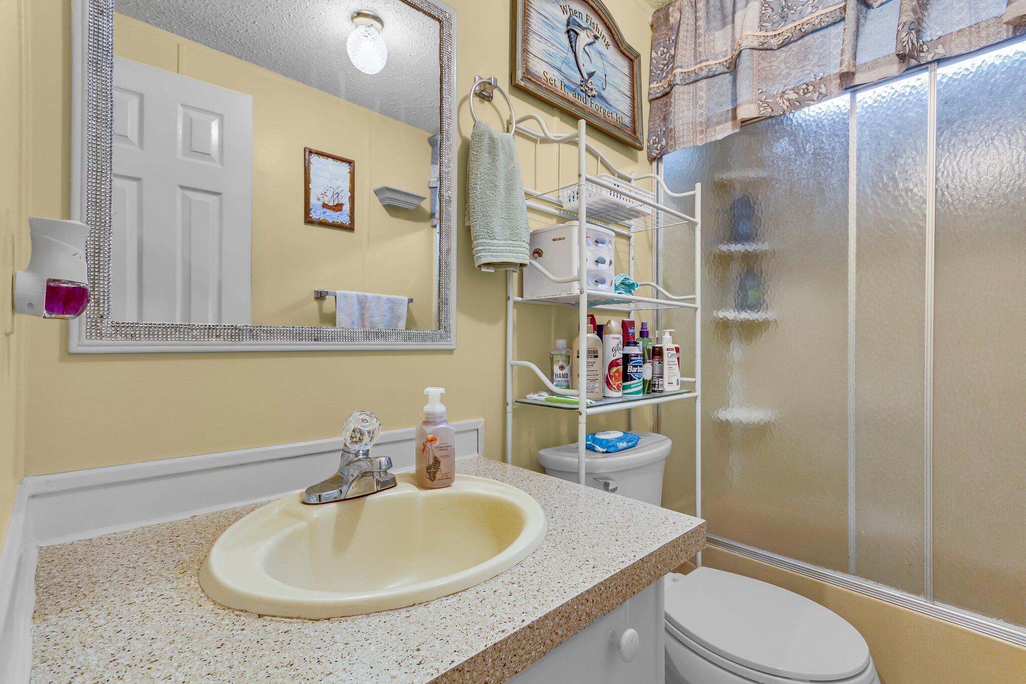 2 Sarah Lane Fort Walton Beach, FL 32547 - Photo 16 of 41 a bathroom with a sink a toilet and shower curtain