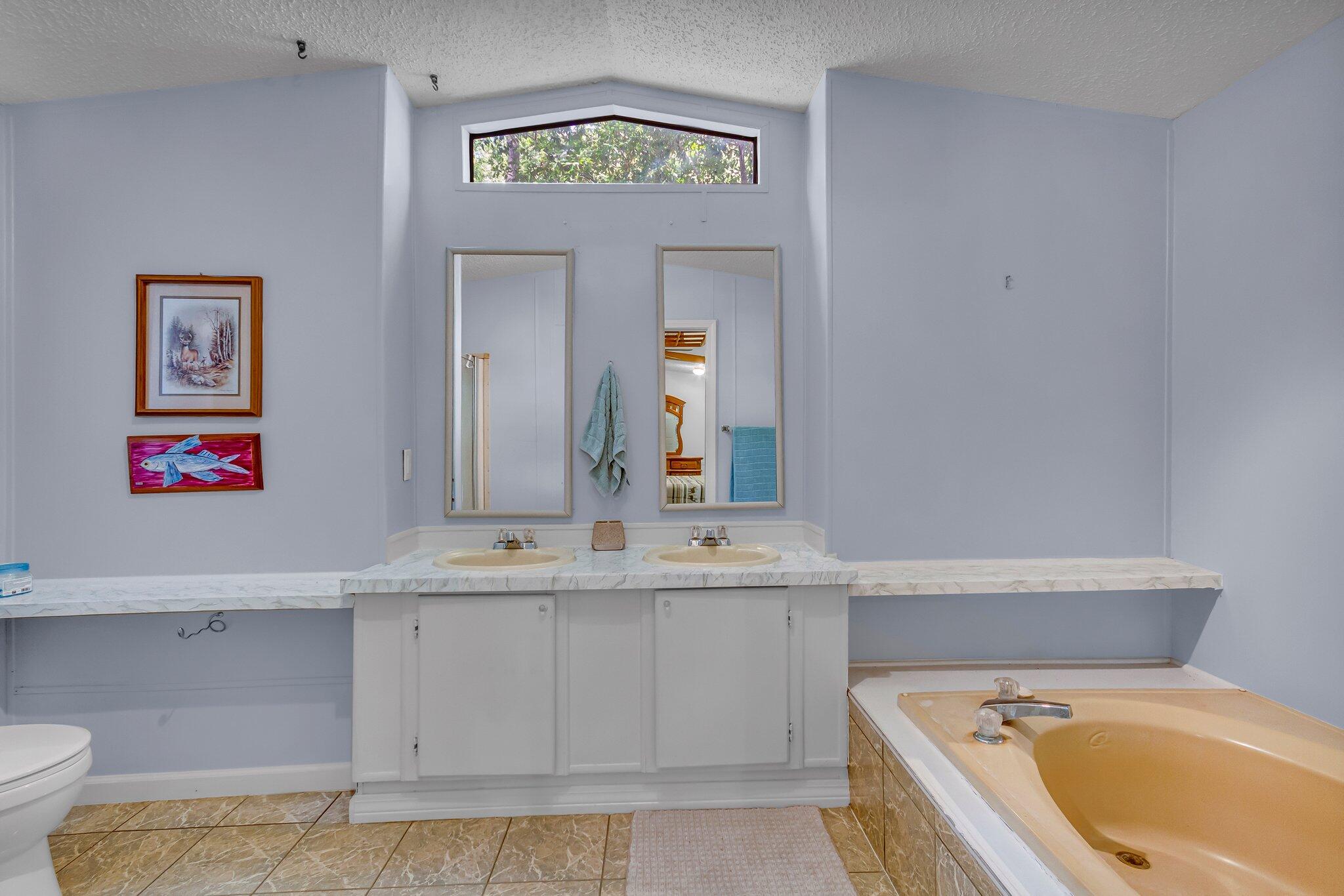 2 Sarah Lane Fort Walton Beach, FL 32547 - Photo 24 of 41 a bathroom with a granite countertop tub sink and mirror