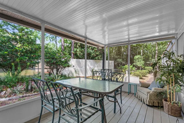 a patio with yard glass top table and chairs