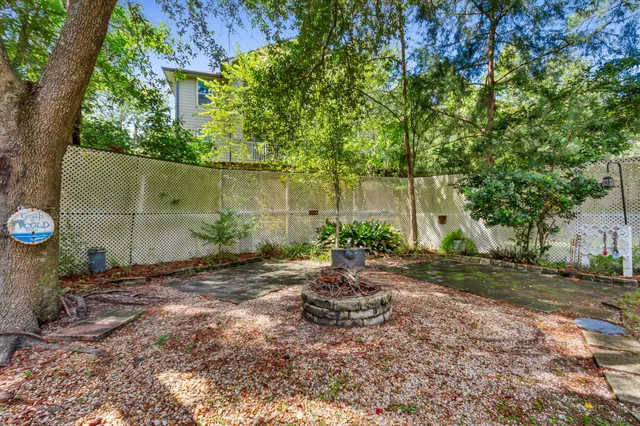 a backyard of a house with plants and tree