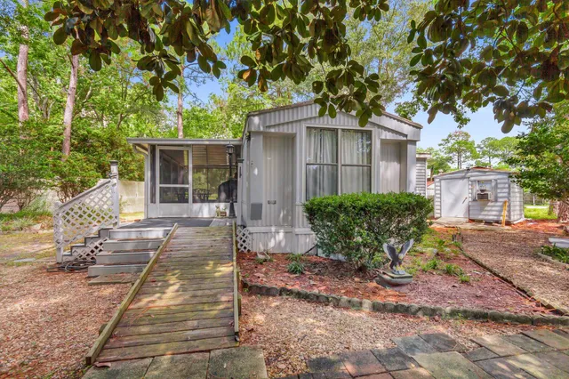 a view of a house with backyard and sitting area