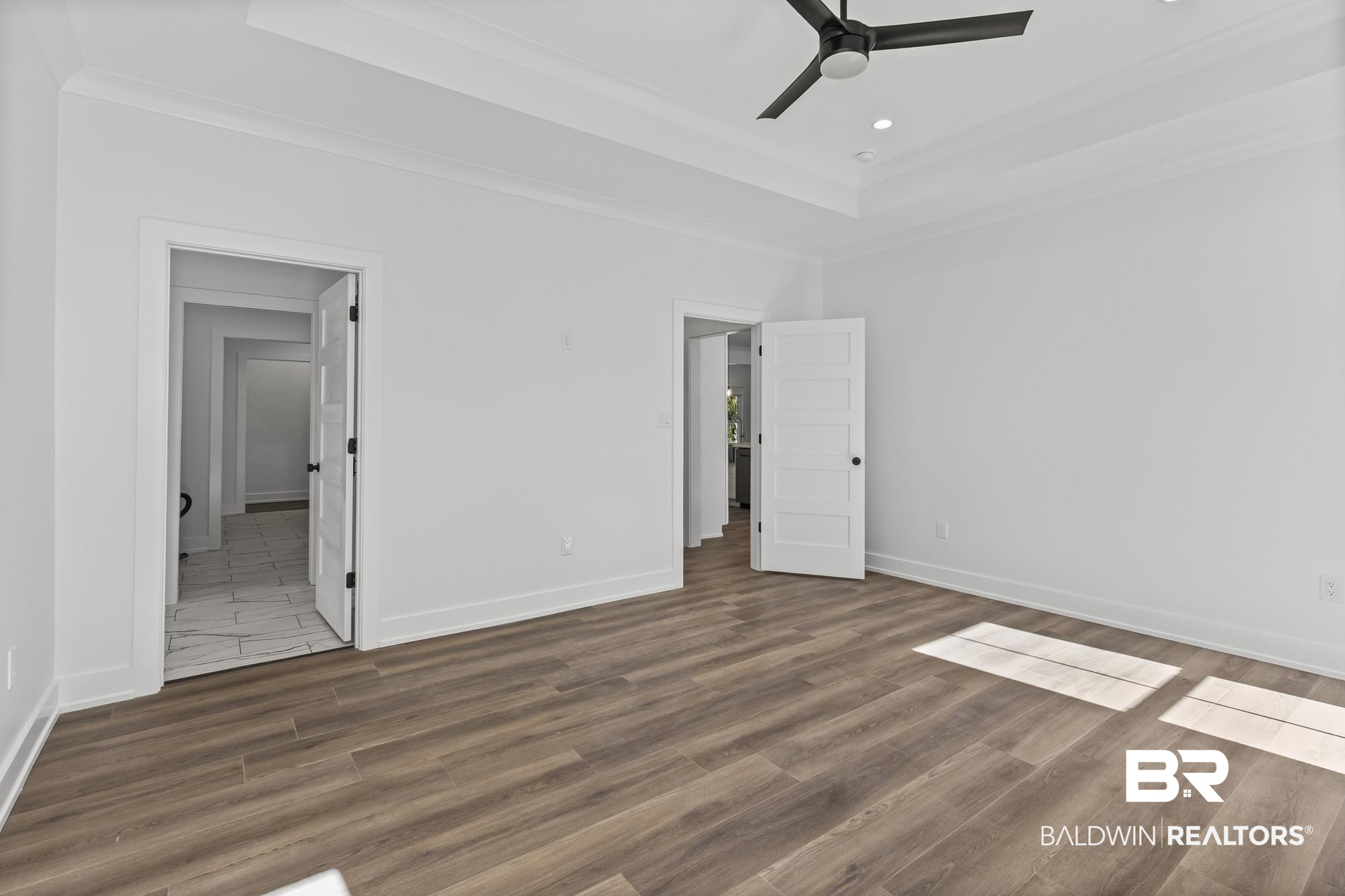 10180 Pineview Drive Foley, AL 36535 - Photo 18 of 47 Unfurnished bedroom featuring a raised ceiling, wood finished floors, ceiling fan, ornamental molding, and recessed lighting