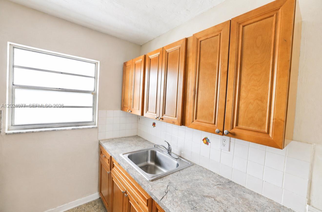 2315 West Okeechobee Road, Unit 304 Hialeah, FL 33010 - Photo 2 of 8 a kitchen with stainless steel appliances granite countertop a sink and a window