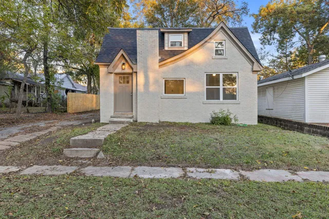a front view of a house with garden