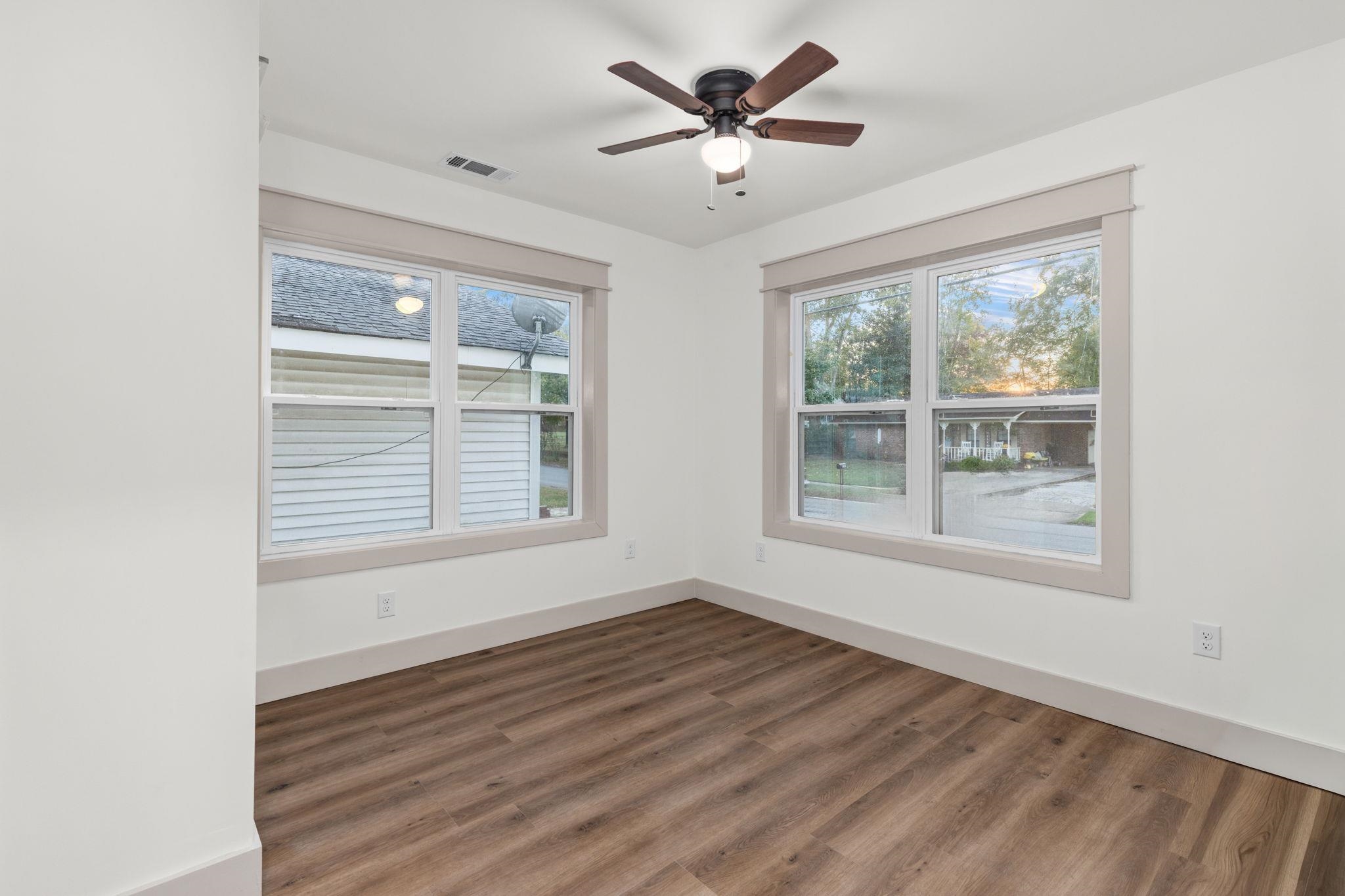 1008 North Madison Street Corinth, MS 38834 - Photo 12 of 33 a view of an empty room with wooden floor and a window