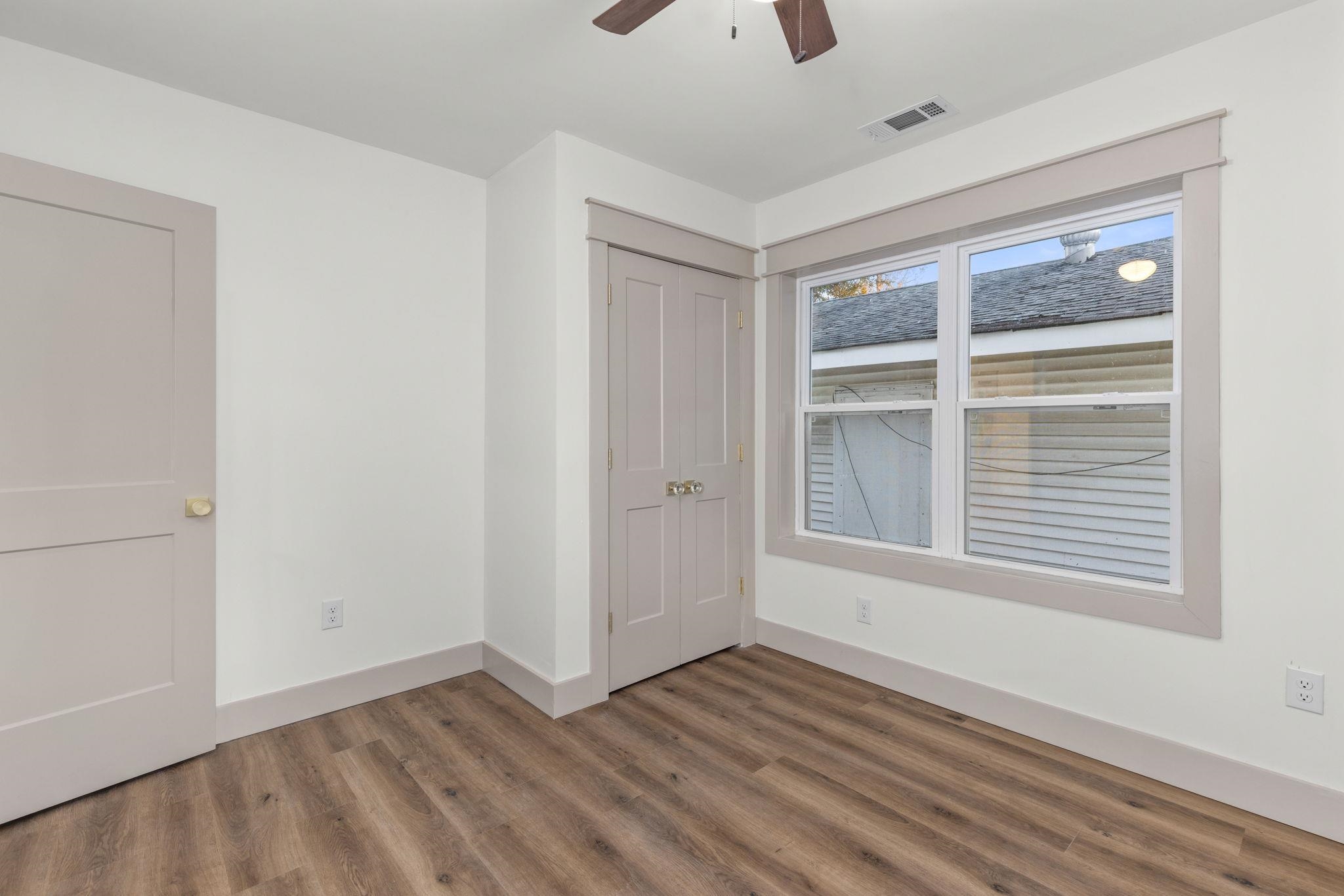 1008 North Madison Street Corinth, MS 38834 - Photo 13 of 33 a view of an empty room with wooden floor and a window