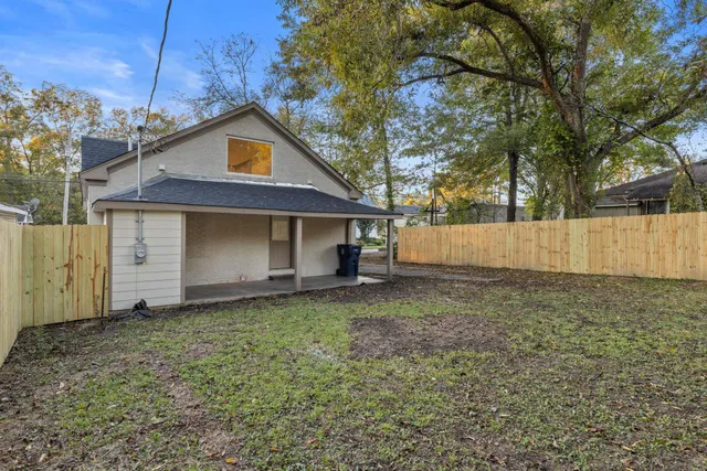 a house that has a tree in front of it