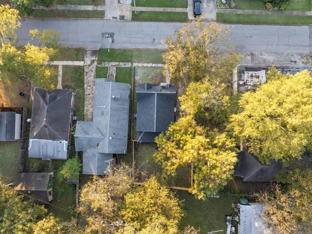a aerial view of a house with a yard and garden
