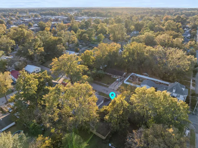 an aerial view of a house with a yard