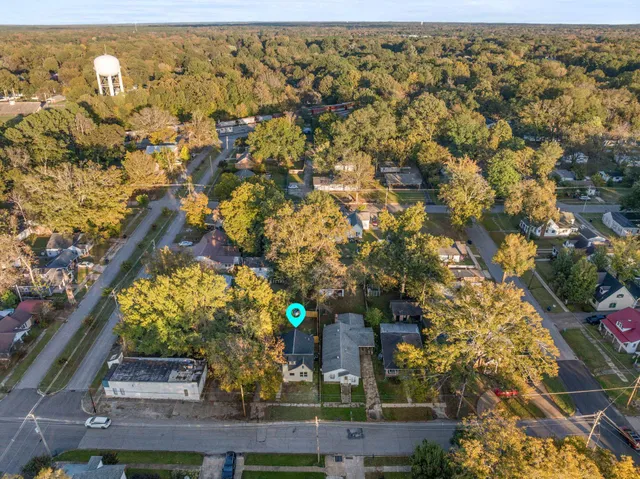 an aerial view of a house with a yard