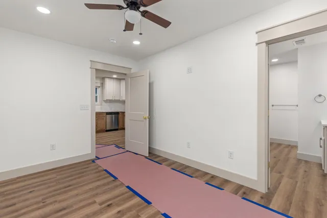 wooden floor in an empty room with a window