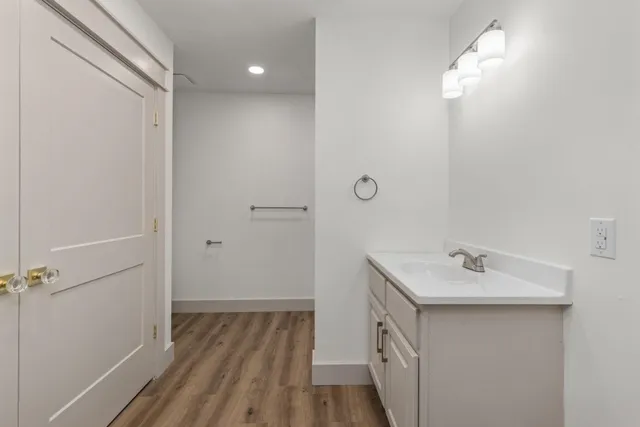a bathroom with a sink a mirror and vanity