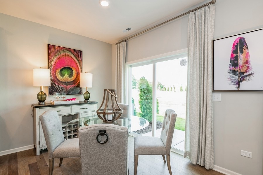 1323 Draper Road McHenry, IL 60050 - Photo 7 of 17 a view of a dining room with furniture wooden floor and window