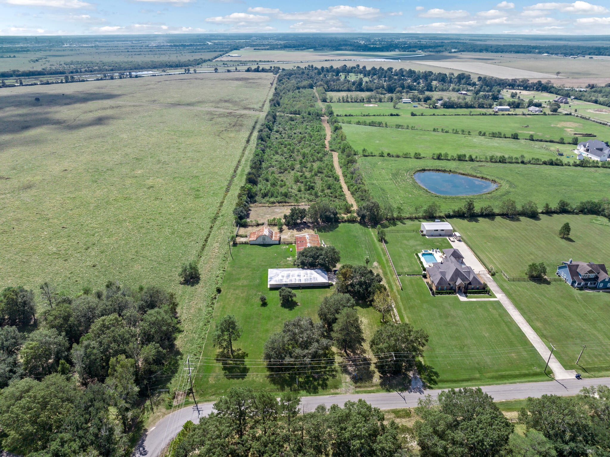 an aerial view of a residential houses with outdoor space and river