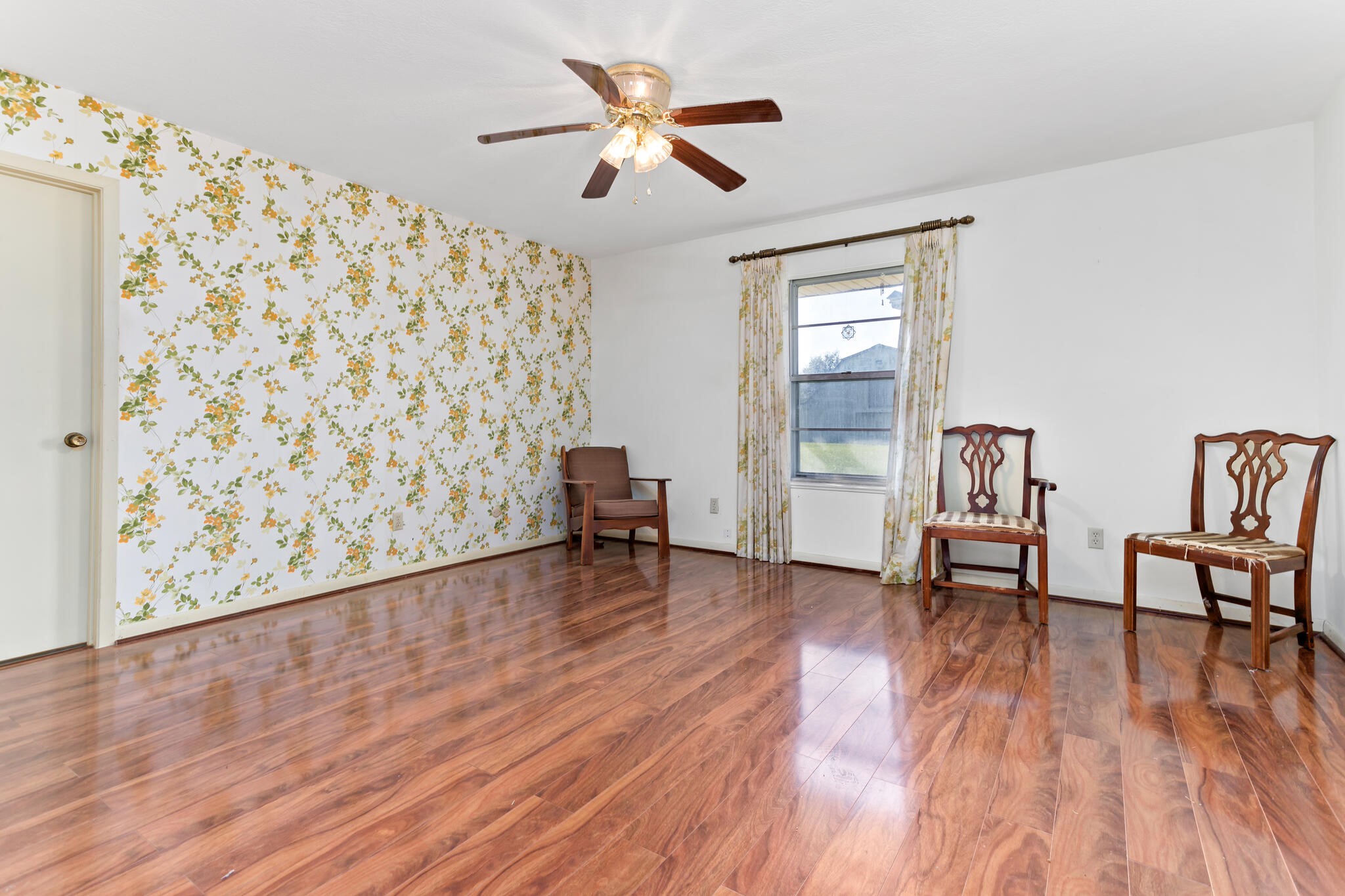 3030 Moore Road Beaumont, TX 77713 - Photo 14 of 38 an empty room with wooden floor and a ceiling fan
