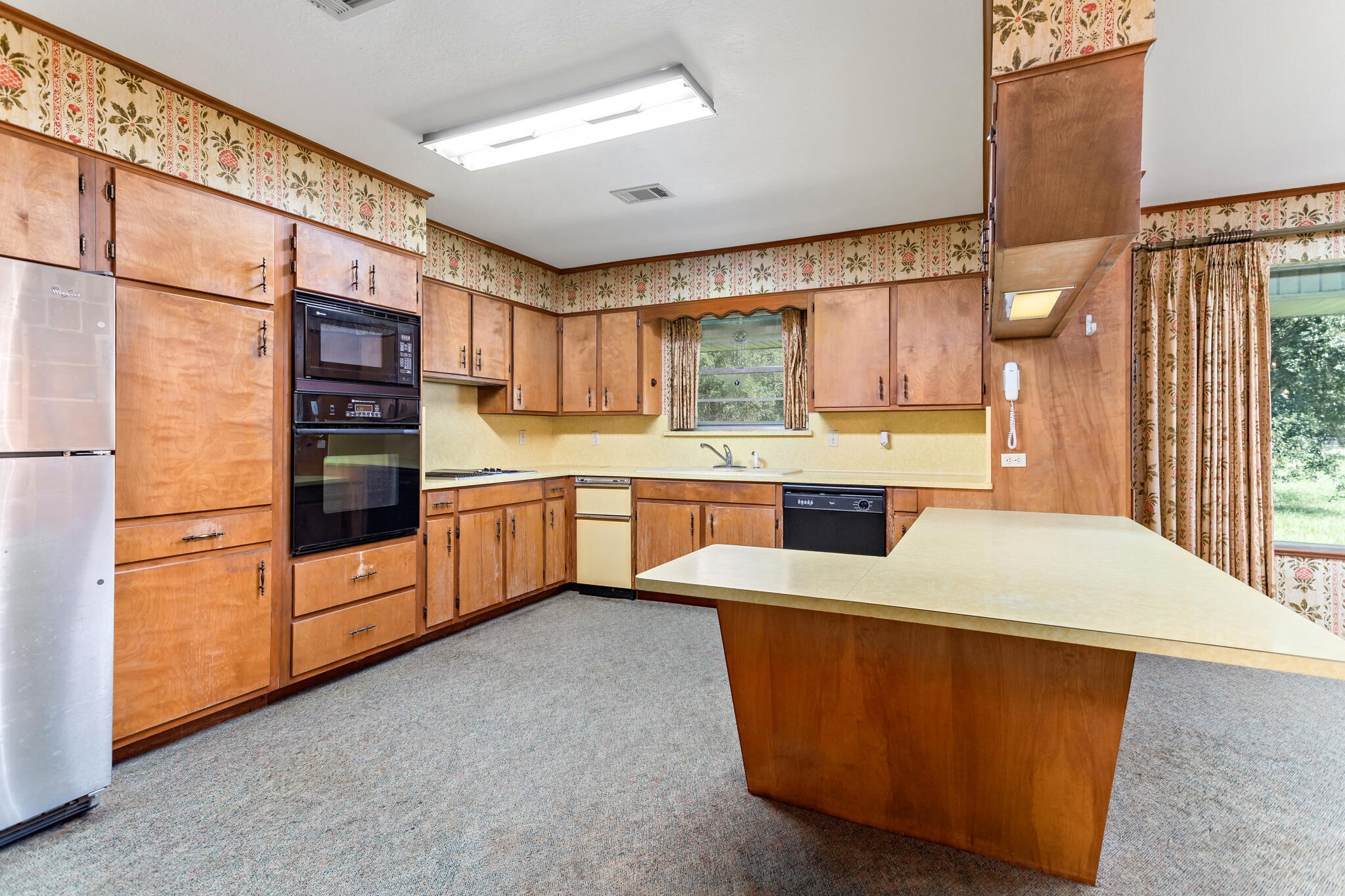 3030 Moore Road Beaumont, TX 77713 - Photo 16 of 38 a kitchen with stainless steel appliances kitchen island granite countertop a refrigerator and a stove top oven