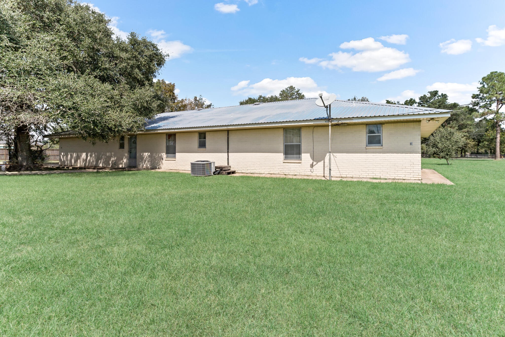 3030 Moore Road Beaumont, TX 77713 - Photo 35 of 38 a view of a house with a big yard and large trees