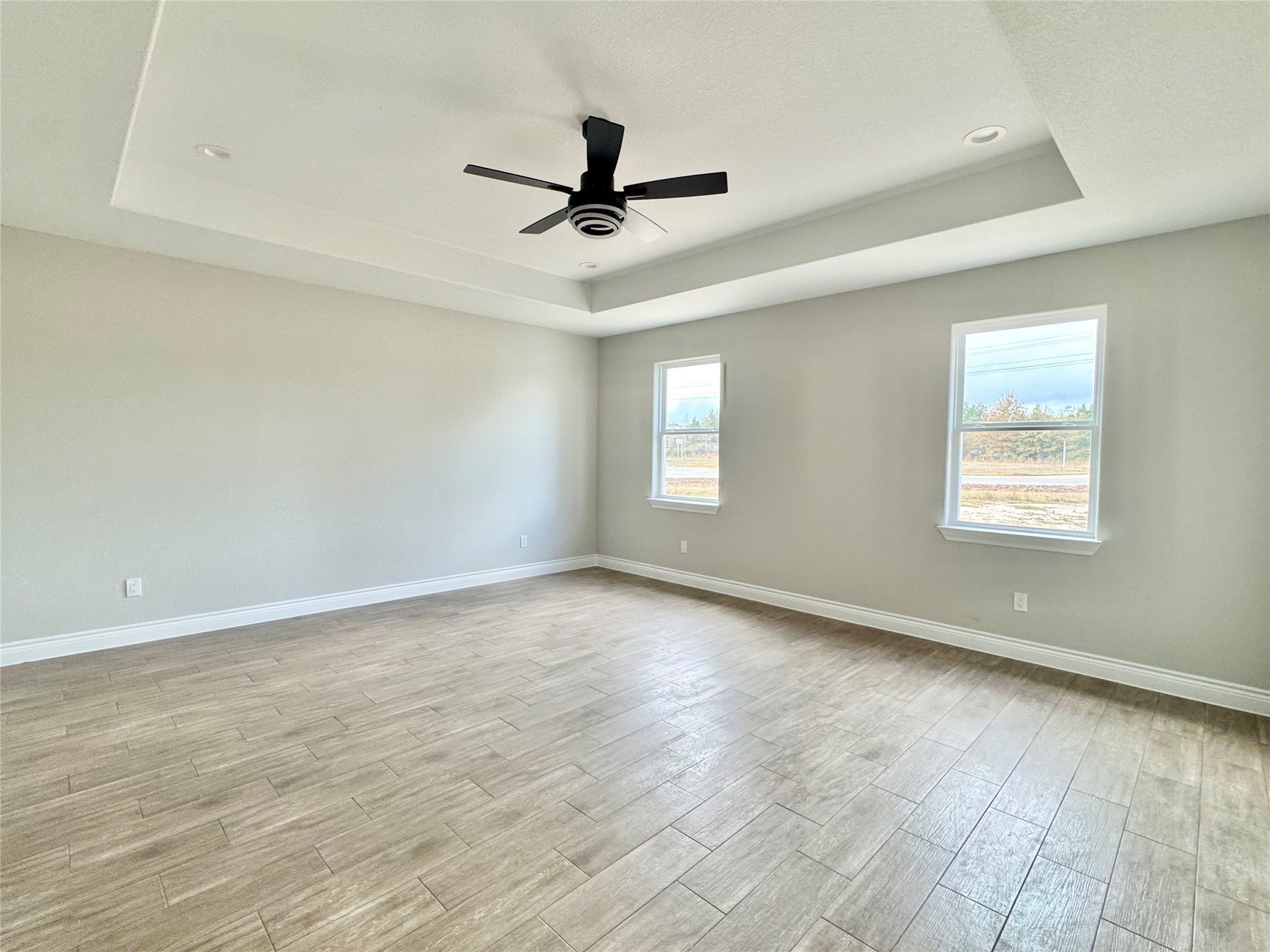 1165 Road 5203 Cleveland, TX 77327 - Photo 15 of 20 an empty room with wooden floor fan and windows