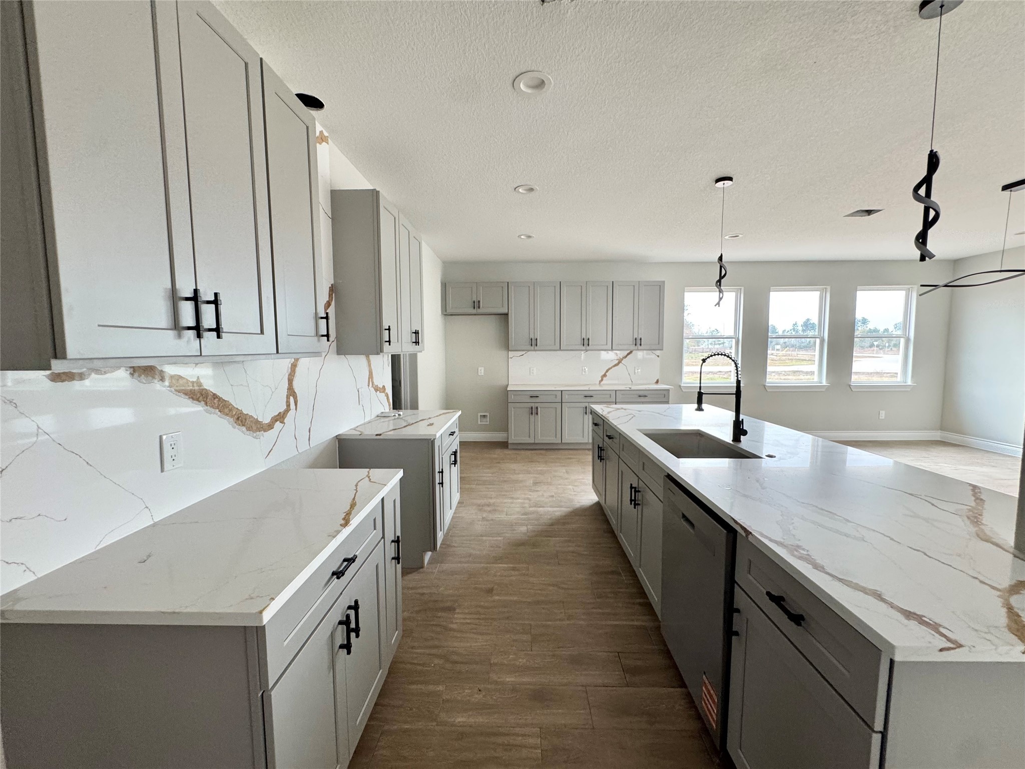 1165 Road 5203 Cleveland, TX 77327 - Photo 9 of 20 a large kitchen with kitchen island a sink stove and wooden floor